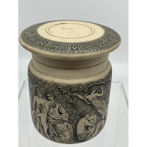 740 - A STONEWARE POT WITH LID SHOWING MUSICAL AND FOREST SCENES 3in Tall