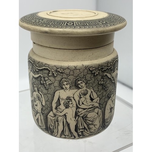 740 - A STONEWARE POT WITH LID SHOWING MUSICAL AND FOREST SCENES 3in Tall