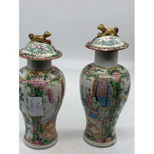 757 - A PAIR OF CHINESE URNS THE LIDS MOUNTED WITH FOO DOGS AND 4 MARKINGS TO BASE 8.5