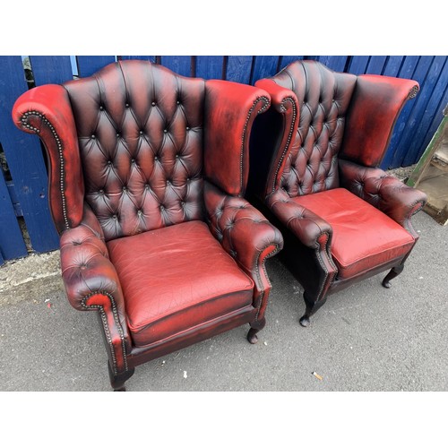 703 - A MATCHING PAIR OF OXBLOOD WINGBACK ARMCHAIRS QUEEN ANNE LEG