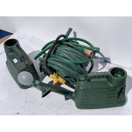 100A - 2 WATERING CANS AND A HOSE ON REEL