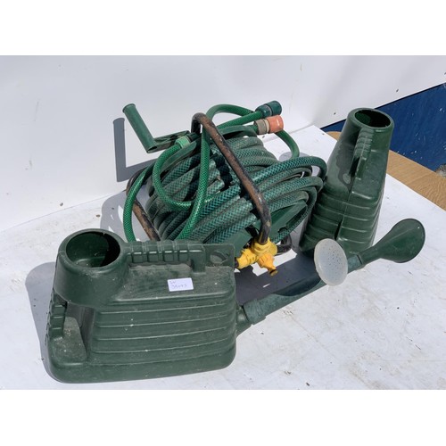 100A - 2 WATERING CANS AND A HOSE ON REEL