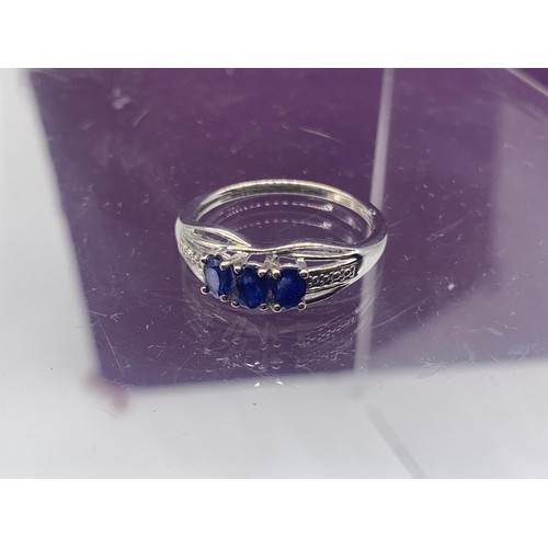 203A - AN ORNATE SILVER BLUE STONE SET RING