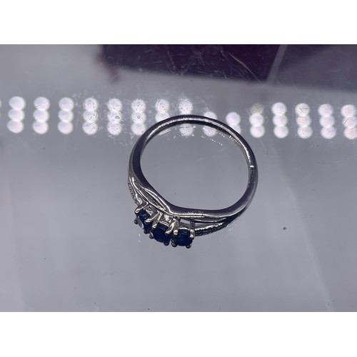 203A - AN ORNATE SILVER BLUE STONE SET RING