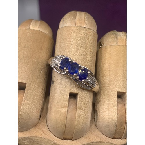 203A - AN ORNATE SILVER BLUE STONE SET RING