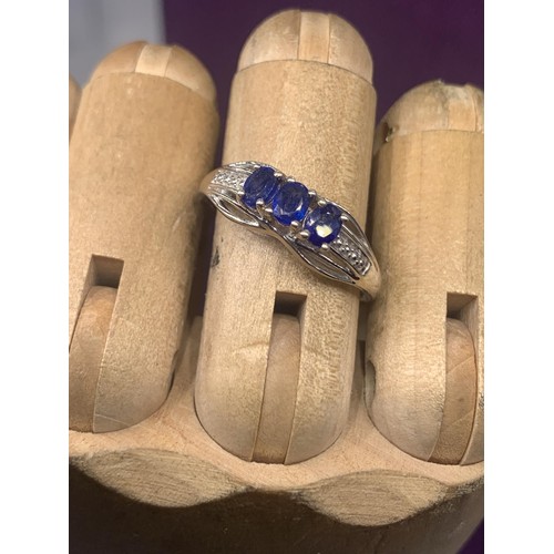 203A - AN ORNATE SILVER BLUE STONE SET RING