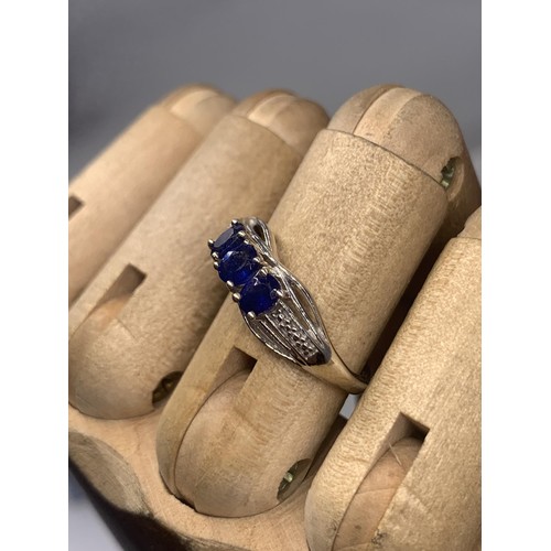 203A - AN ORNATE SILVER BLUE STONE SET RING