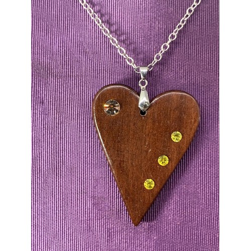 231 - A WOODEN HEART SET WITH STONE ON A SILVER CHAIN