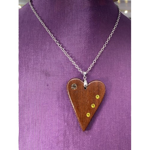 231 - A WOODEN HEART SET WITH STONE ON A SILVER CHAIN