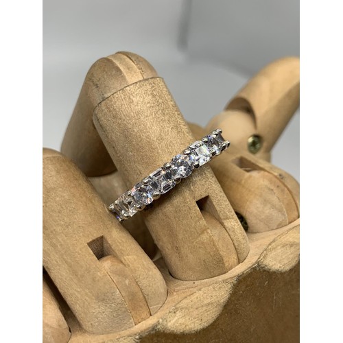 257 - A HEAVY SILVER DESIGNER STYLE GEM SET ETERNITY RING