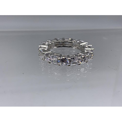 257 - A HEAVY SILVER DESIGNER STYLE GEM SET ETERNITY RING