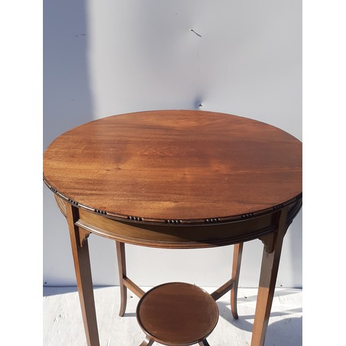 519 - AN EDWARDIAN MAHOGANY SIDE TABLE GOING ON TO A SPLAYED FOOT