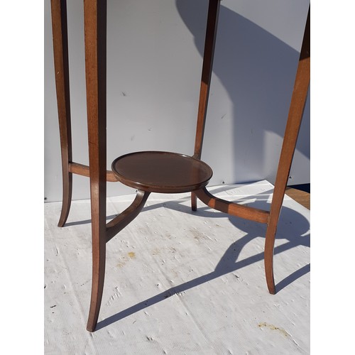 519 - AN EDWARDIAN MAHOGANY SIDE TABLE GOING ON TO A SPLAYED FOOT