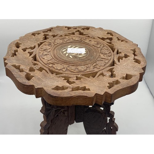 570 - A SMALL INDIAN CARVED TABLE WITH M.O.P. INLAY ON TRIPOD BASE