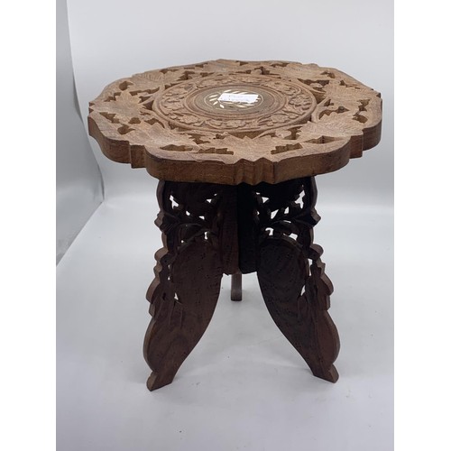 570 - A SMALL INDIAN CARVED TABLE WITH M.O.P. INLAY ON TRIPOD BASE