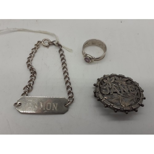 597 - A SILVER RING, A SILVER ID BRACELET AND SILVER BROOCH