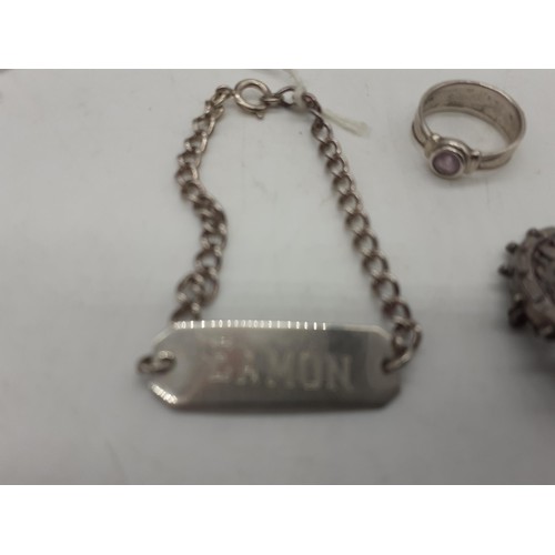 597 - A SILVER RING, A SILVER ID BRACELET AND SILVER BROOCH