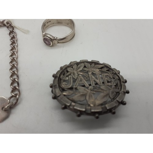 597 - A SILVER RING, A SILVER ID BRACELET AND SILVER BROOCH