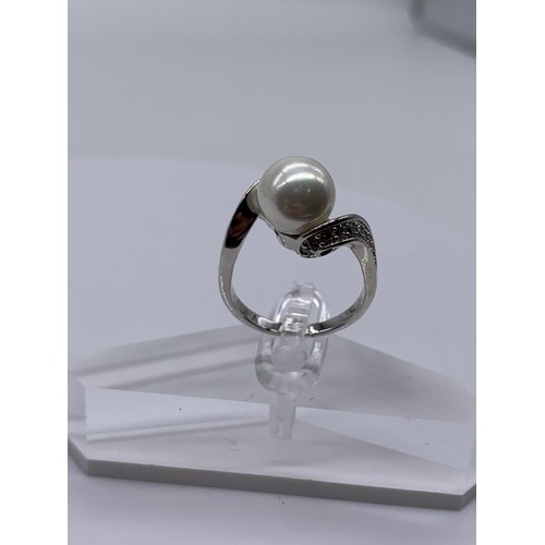 655 - A BOXED PEARL AND CRYSTAL RING