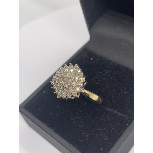 705 - A 9ct GOLD DIAMOND CLUSTER RING