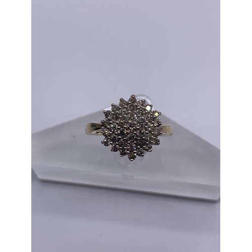 705 - A 9ct GOLD DIAMOND CLUSTER RING