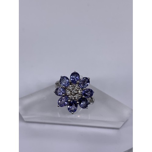 710 - 9ct WHITE GOLD DIAMOND AND TANZANITE RING size o