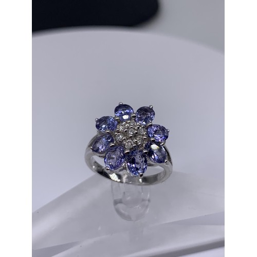 710 - 9ct WHITE GOLD DIAMOND AND TANZANITE RING size o