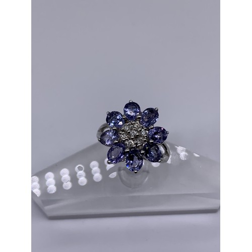 710 - 9ct WHITE GOLD DIAMOND AND TANZANITE RING size o