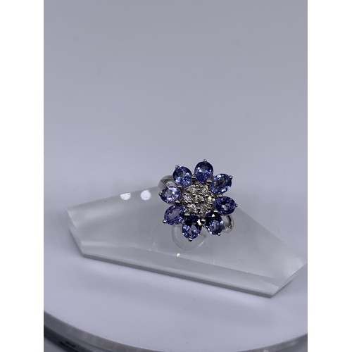 710 - 9ct WHITE GOLD DIAMOND AND TANZANITE RING size o