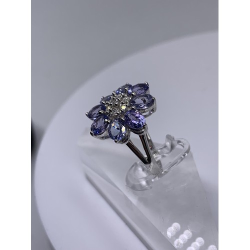 710 - 9ct WHITE GOLD DIAMOND AND TANZANITE RING size o