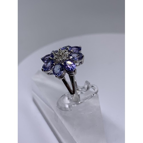 710 - 9ct WHITE GOLD DIAMOND AND TANZANITE RING size o