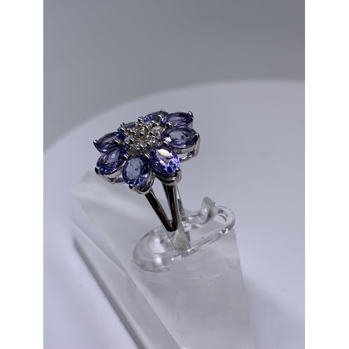 710 - 9ct WHITE GOLD DIAMOND AND TANZANITE RING size o