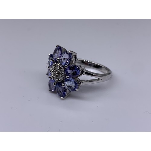 710 - 9ct WHITE GOLD DIAMOND AND TANZANITE RING size o