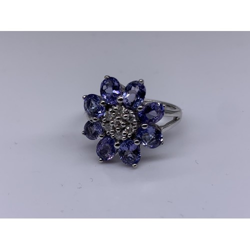 710 - 9ct WHITE GOLD DIAMOND AND TANZANITE RING size o