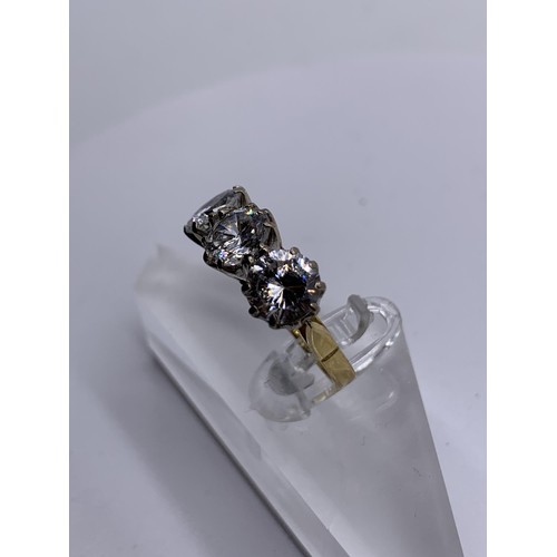 717 - AN 18ct GOLD 3 STONE RING