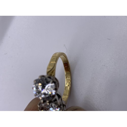 717 - AN 18ct GOLD 3 STONE RING