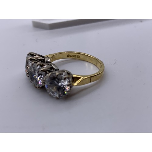 717 - AN 18ct GOLD 3 STONE RING