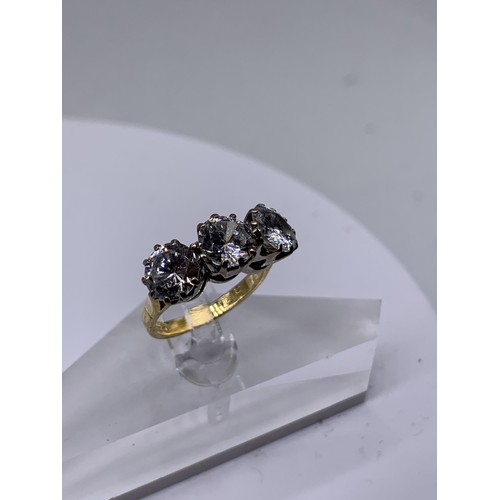 717 - AN 18ct GOLD 3 STONE RING