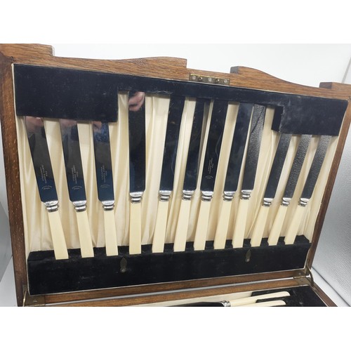 530 - AN OAK CASED CANTEEN OF CUTLERY 47 PIECE (WITH BRASS PLAQUE A PRESENTATION FROM MASONIC LODGE