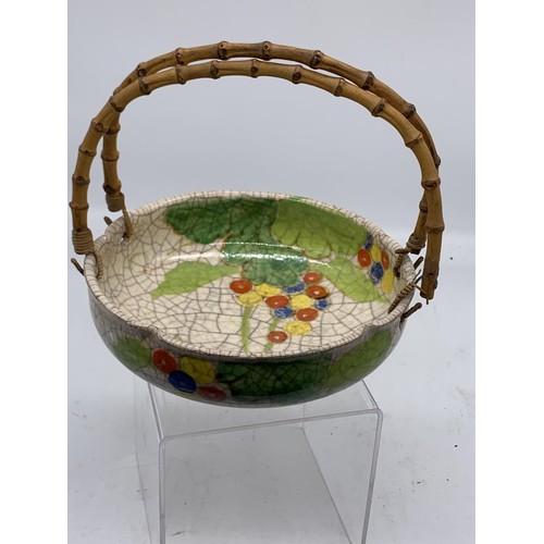 595 - AN ORIENTAL BOWL WITH BAMBOO HANDLE