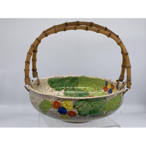 595 - AN ORIENTAL BOWL WITH BAMBOO HANDLE