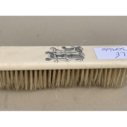 619 - AN ANTIQUE BONE HANDLED CLOTHES BRUSH