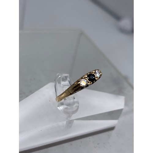 673 - A SAPPHIRE AND DIAMOND 18ct RING size q