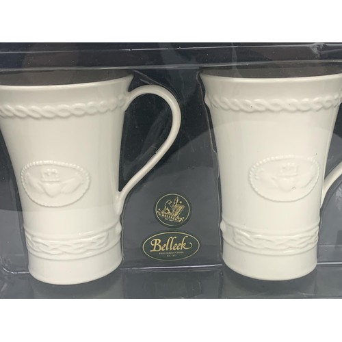 57 - A BOXED PAIR OF BELLEEK CLADDAGH  MUGS FOR LATTE