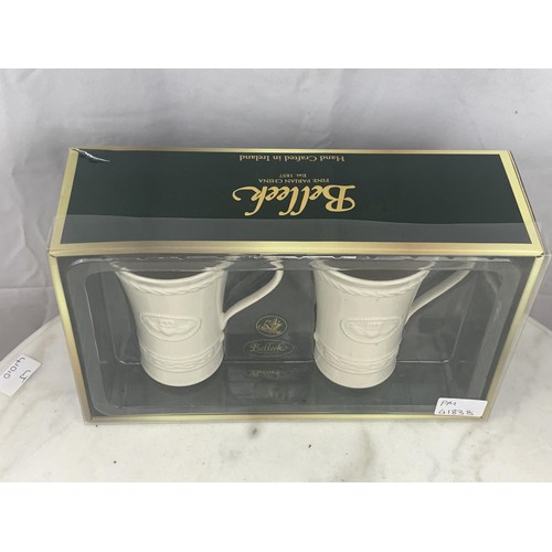 57 - A BOXED PAIR OF BELLEEK CLADDAGH  MUGS FOR LATTE