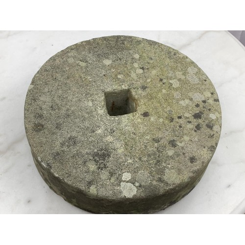 110 - AN ANTIQUE MILL STONE 12