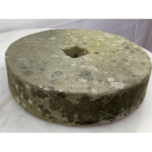 110 - AN ANTIQUE MILL STONE 12