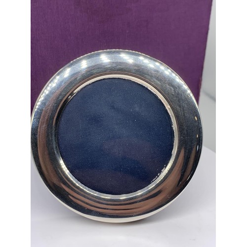 164 - A SMALL CIRCULAR SILVER PHOTO FRAME