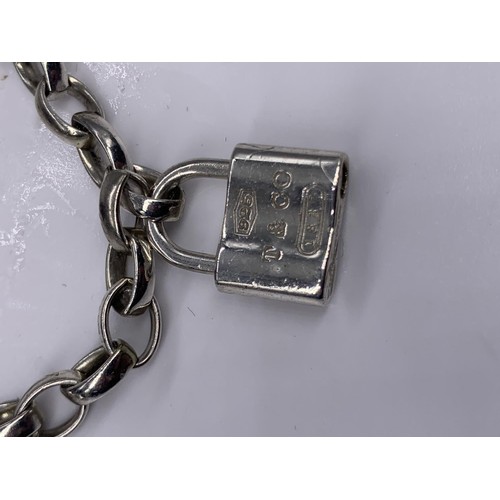 169 - A GENUINE TIFFANY SILVER BRACELET WITH 4 DETACHABLE CHARMS WITH CLASPS COMPRISING OF LOCK STAMPED T&... 