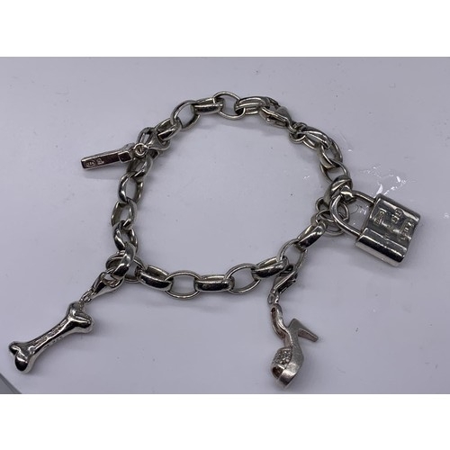 169 - A GENUINE TIFFANY SILVER BRACELET WITH 4 DETACHABLE CHARMS WITH CLASPS COMPRISING OF LOCK STAMPED T&... 
